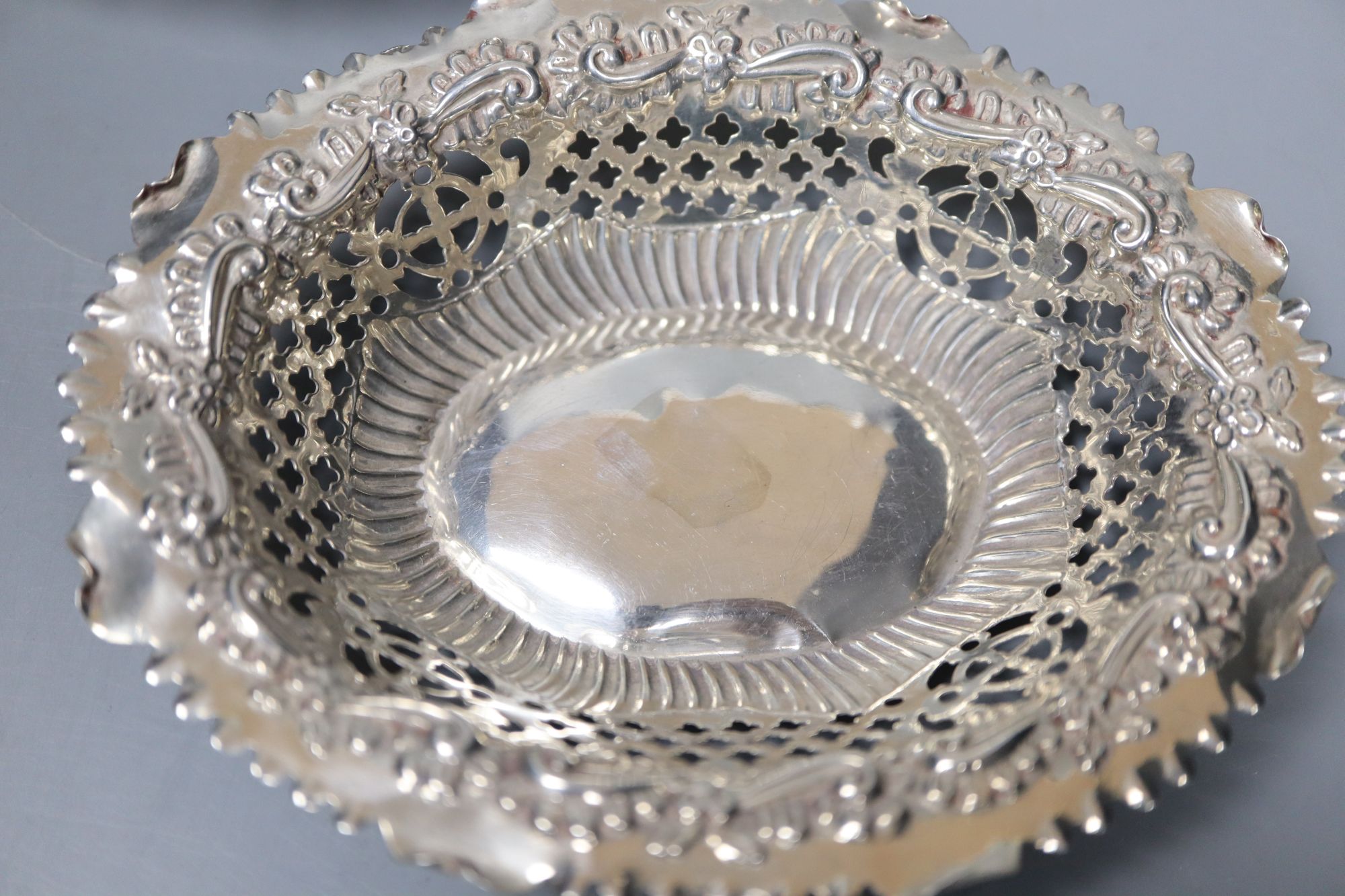 A late Victorian repousse silver bon bon dish and two similar Edwardian dishes, largest 16.8cm, 159 grams.